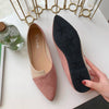 Woman walking in comfortable pointed toe flats on city street