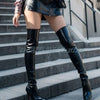 Close-up of the sleek matte black finish on stiletto over-the-knee boots.