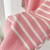 Knitted scarf with classic stripes, ideal for cooler days.