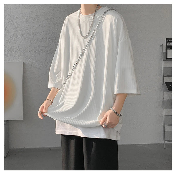 Model in striped summer tee, demonstrating versatility for both men and women.