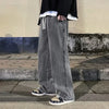 Black cotton denim jeans with relaxed wide-leg silhouette and elastic closure