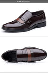 Lace-up closure of stylish black leather Oxford brogue shoes.