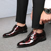 Close-up of floral pattern on elegant men's Oxford dress shoes.