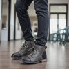 Brown leather ankle boots featuring quick-access side zipper and low heel