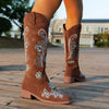 Embroidered mid-calf women's fashion boots with low wedge heel, slip-on design, and durable rubber outsole for comfort.