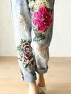 Vintage floral embroidered high-waist denim jeans with a loose fit, perfect for casual wear and stylish outfits.