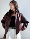Close-up of the stand collar on the chic vintage leather cropped jacket for women.