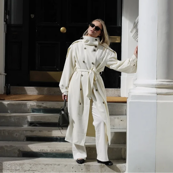 Neutral cream long trench coat perfect for layering over autumn and winter outfits