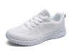 Women's white running shoes with breathable mesh and colorful design