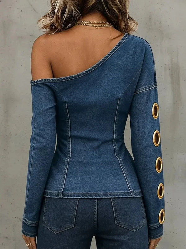 Modern denim top featuring architectural metal ring hardware and diagonal asymmetric hemline design