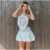 Model wearing complete two-piece lace set at formal event