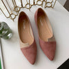 Woman wearing comfortable pointed toe flats during morning commute