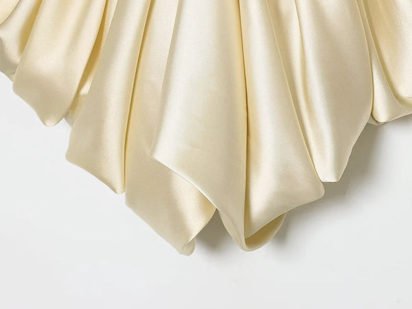 Versatile pleated satin camisole featuring daring backless cut