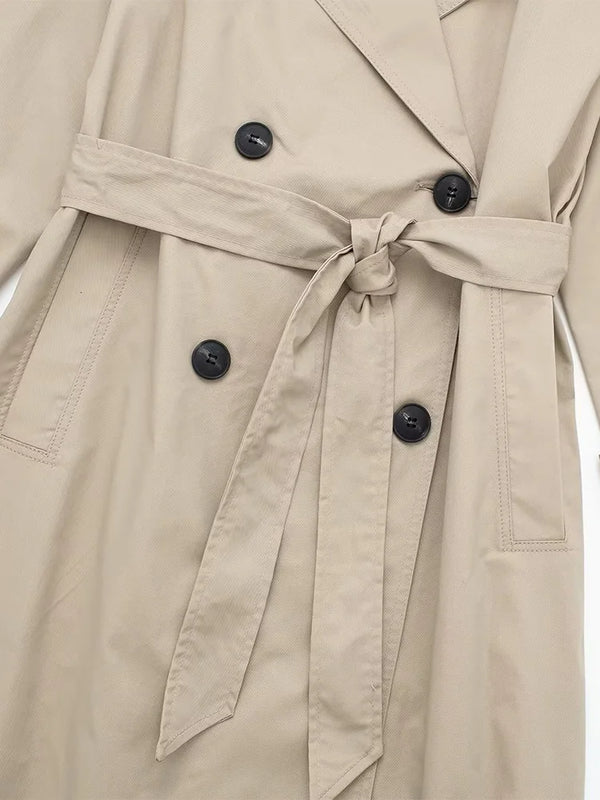X-long trench coat showing graceful movement and dramatic flowing silhouette