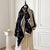 Luxe cashmere shawl in vibrant floral print, perfect for winter elegance.