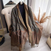 Lightweight paisley pashmina scarf draped over shoulders, showcasing tassels.