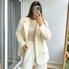 Creamy white mohair blazer paired with tailored trousers for sophisticated office look