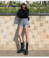 High waist jean shorts with artful tears and tassel trim for street style look