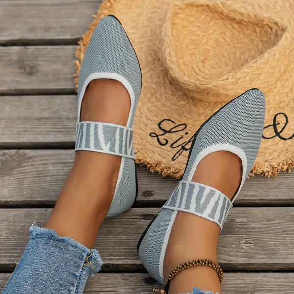Close-up of breathable knitted fabric and color-block artistry on pointed toe flat shoes