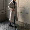 Men's long double-breasted trench coat in solid color with turn-down collar, perfect for autumn and winter streetwear.