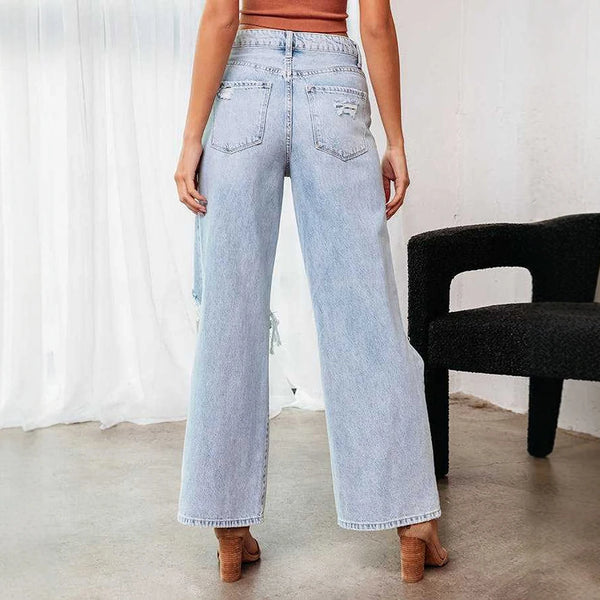 Model wearing trendy ripped ankle jeans, showcasing casual chic summer style.