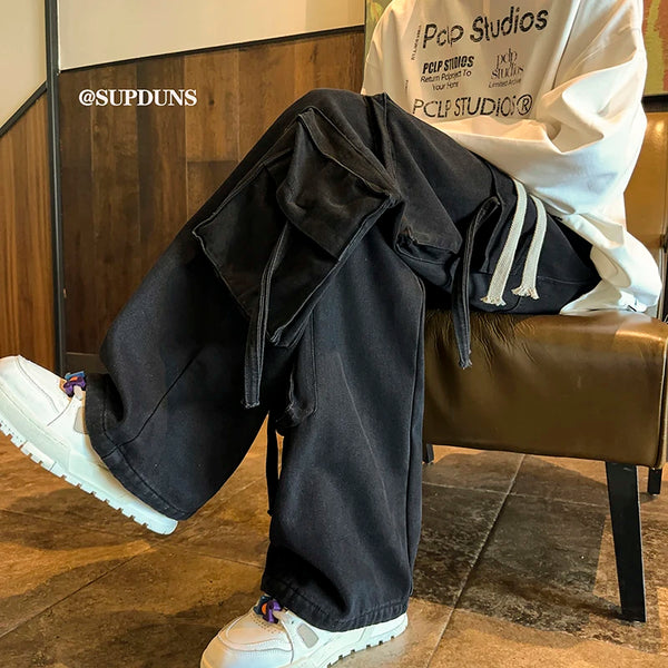 Side view of men's wide-leg hip-hop jeans with adjustable drawstring.