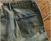 Rebel Spirit Distressed Jeans on display with nature backdrop, embodying rugged refinement.