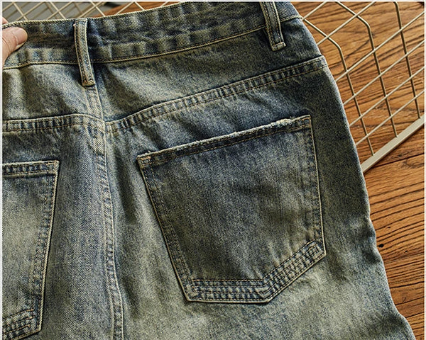 Rebel Spirit Distressed Jeans on display with nature backdrop, embodying rugged refinement.