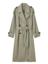 Side view of belted double-breasted trench showing flattering tailored fit