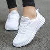 Women's white athletic shoes with vibrant colorful details and mesh lining