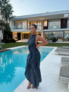 Elegant pullover halter dress featuring flattering ruched detailing and asymmetrical shape
