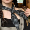 Versatile cotton-linen scarf styled as a neck kerchief.