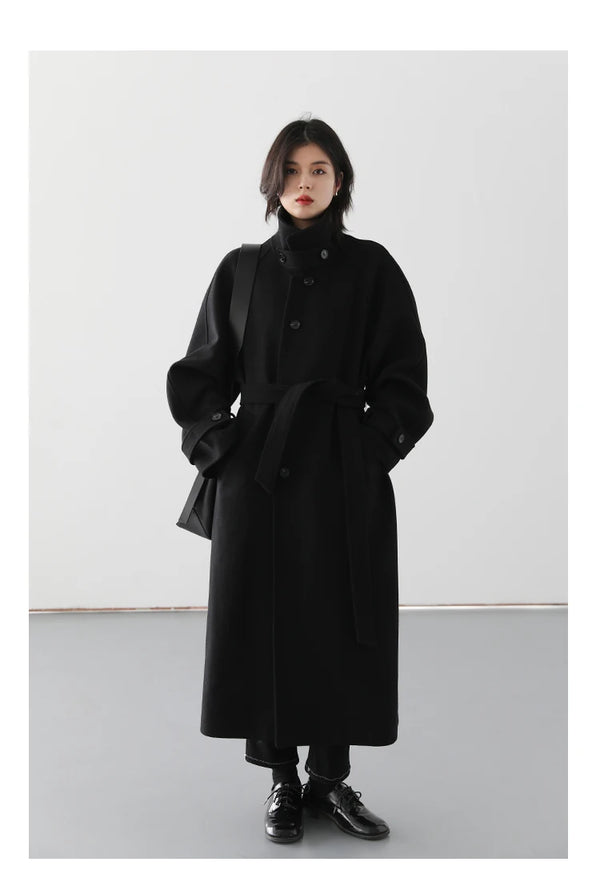 Elegant belted woolen coat in timeless silhouette with modern details