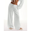 Model wearing wide leg pants in natural light, highlighting flowing fabric and flattering fit