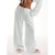 Model wearing wide leg pants in natural light, highlighting flowing fabric and flattering fit
