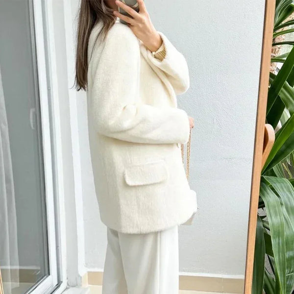 Detail of mohair blazer sleeve showing quality construction and creamy white color