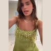 Statement sequin mini dress in green with hourglass silhouette and fringe accents