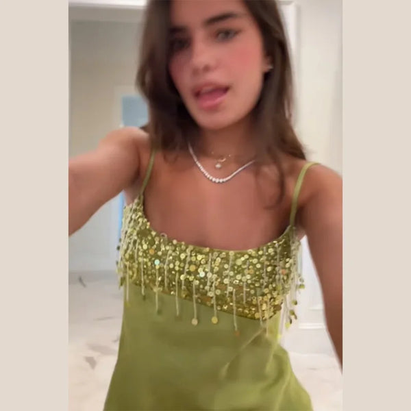 Statement sequin mini dress in green with hourglass silhouette and fringe accents