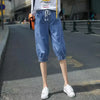 Calf-length harem jeans featuring high-waist design and breathable cotton-polyester blend
