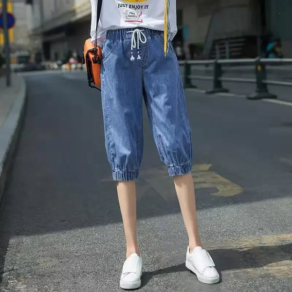 Calf-length harem jeans featuring high-waist design and breathable cotton-polyester blend