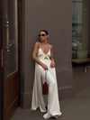 Side view of white satin two-piece showing elongating high-waist design