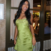 Sparkly green mini dress featuring square neckline and shimmering sequin embellishment