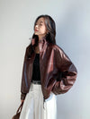 Model showcasing the stand collar of the chic vintage leather cropped jacket.