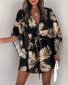 Woman wearing flowing floral print dress with asymmetrical ruffle hemline and relaxed fit