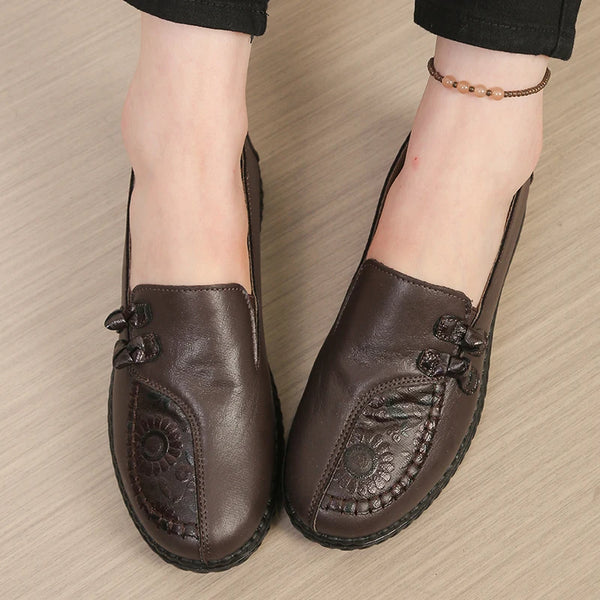 Close-up of buttery-soft leather loafer showing detailed floral embellishment
