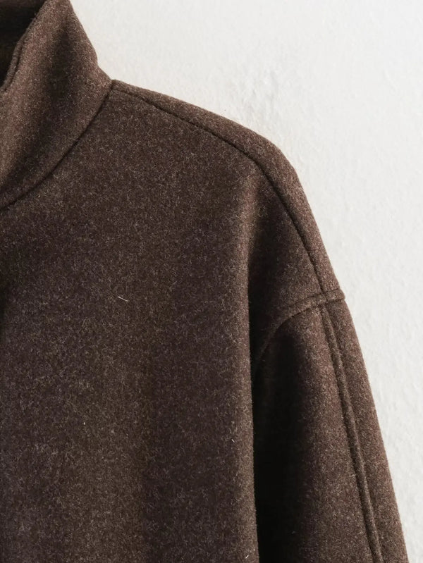 Zip-front outerwear with sash belt and sophisticated turtleneck collar detail