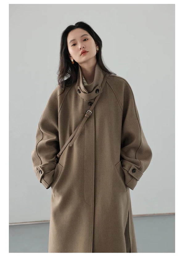 Classic trench coat silhouette with turtleneck and adjustable belt accent