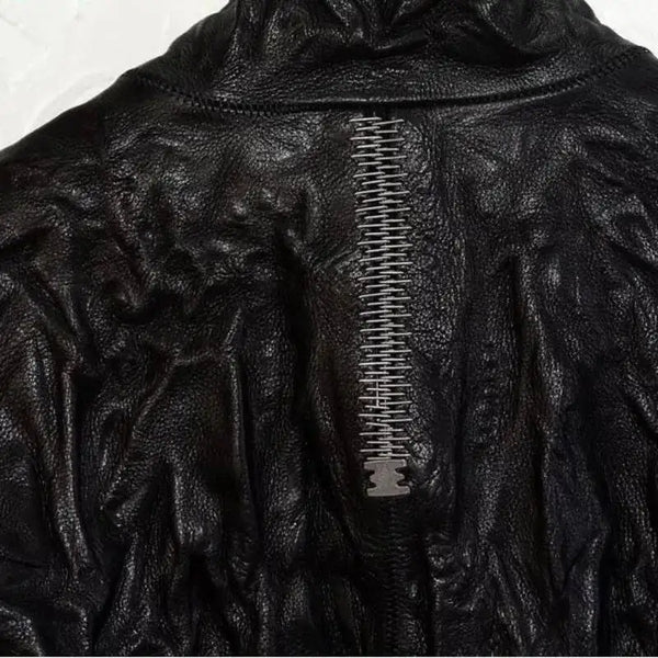 Close-up of high-quality calf skin leather on HKSH men's punk jacket, showcasing intricate details.