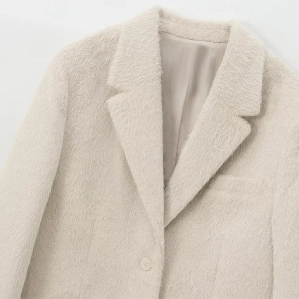 Woman wearing white mohair blazer over knit sweater demonstrating layering versatility