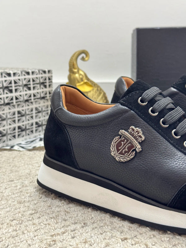 Men's luxury black leather loafers with embroidered accents.